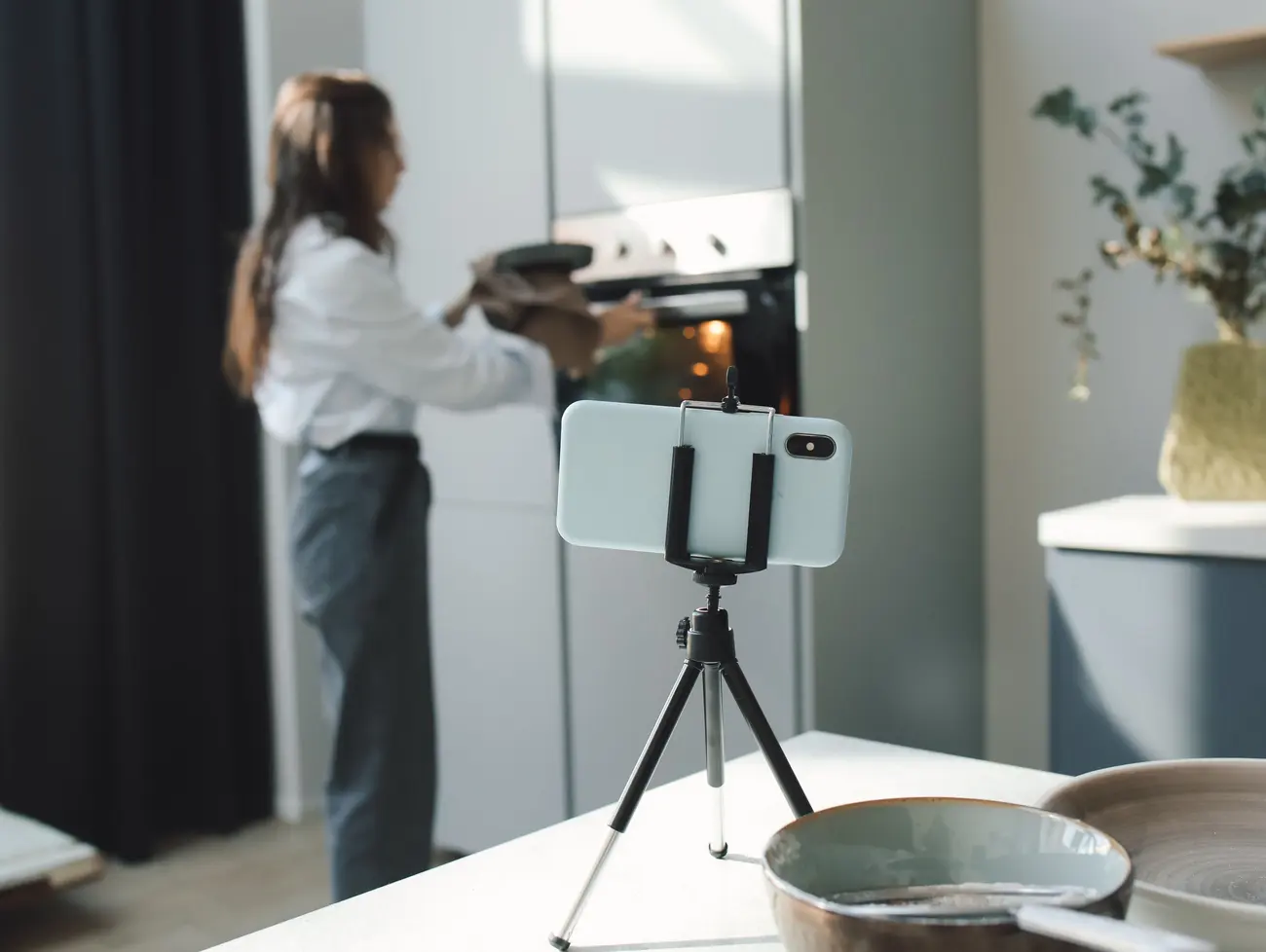 Celular em tripé gravando uma cena real na cozinha, sem produção montada